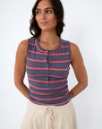 Model wearing striped sleeveless top with front buttons and back detail