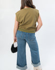 Back view of THML Olive Green Sleeveless Top in soft sweatshirt fabric, styled with wide-leg denim for a casual fall outfit.