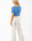 Back view of Z Supply Asher Riviera Blue V-Neck Tee showing relaxed fit and lightweight cotton slub jersey fabric paired with striped pants.