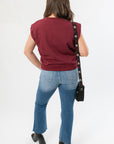 Back view of THML Burgundy Studded Sleeveless Top paired with denim, showcasing relaxed fit and fall-ready style.