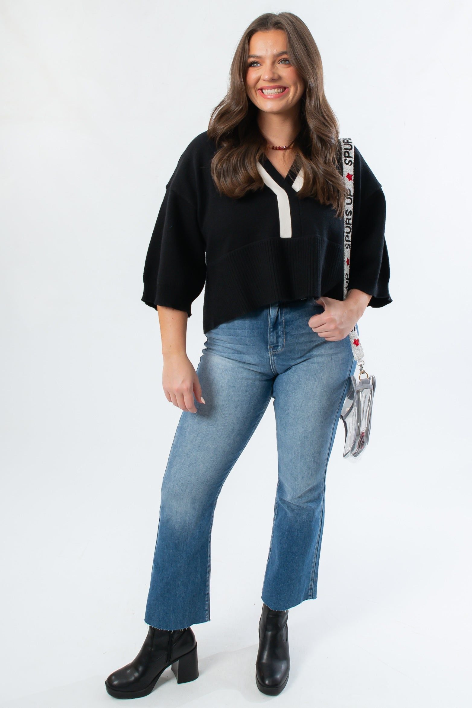 Black Contrast Collared V-Neck Sweater by Angie paired with flare jeans and boots, perfect for gameday or casual fall looks.