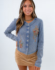 Fitted dusty blue henley shirt with floral detailing, blue henley with flowers on it, ribbed blue henley, dusty blue henley