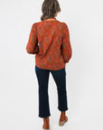 Back view of Carmen Rust Floral Embroidered Blouse showing floral print and relaxed fit, ideal for layering in fall wardrobes.
