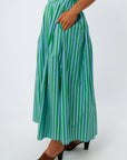 Green and blue striped midi skirt with pleats and elastic waist, worn with white top