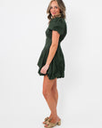 Profile angle of Arden Hunter Green Bubble Dress highlighting tailored fit, short length, and elegant puff sleeve detail.