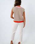 Tan sleeveless sweater with colorful accents, pink and green sweater