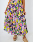 Colorful floral maxi skirt with elastic waist worn by a woman