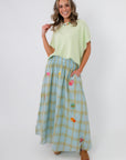 Stylish plaid midi skirt with side pockets and vibrant appliqués