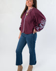 Side view of Glam Wine Long Sleeve Blouse showcasing detailed sleeve embroidery and relaxed fit, ideal for stylish fall outfits.
