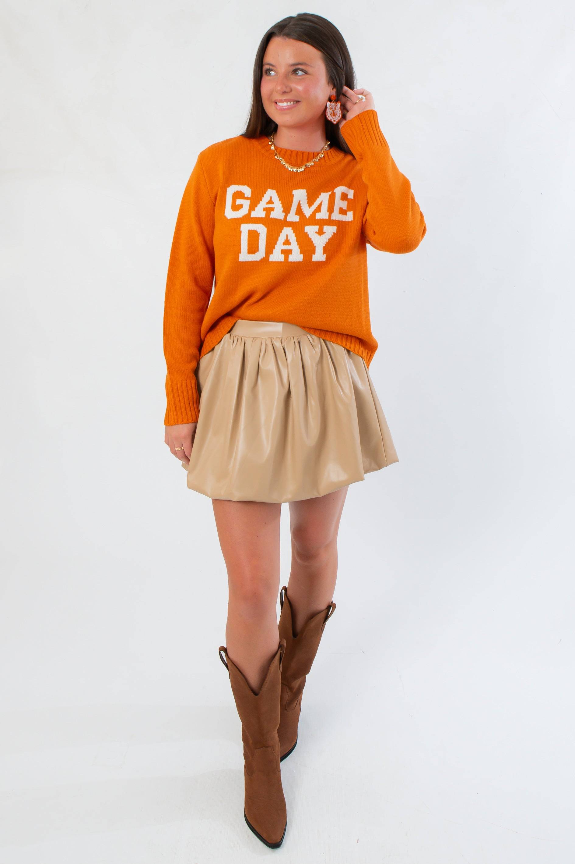 Oversized Game Day Orange Knit Sweater paired with a tan skirt and brown boots, perfect for autumn football weekends.