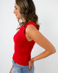 Side profile of woman wearing red sleeveless knit top with open back