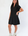 Side view of THML Elise Black Suede Mini Dress highlighting its flattering drop waist and modern short sleeve cut.