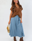 Light Brown V Neck Sweater Vest paired with a blue maxi skirt and brown boots, ideal for autumn fashion and casual layering.