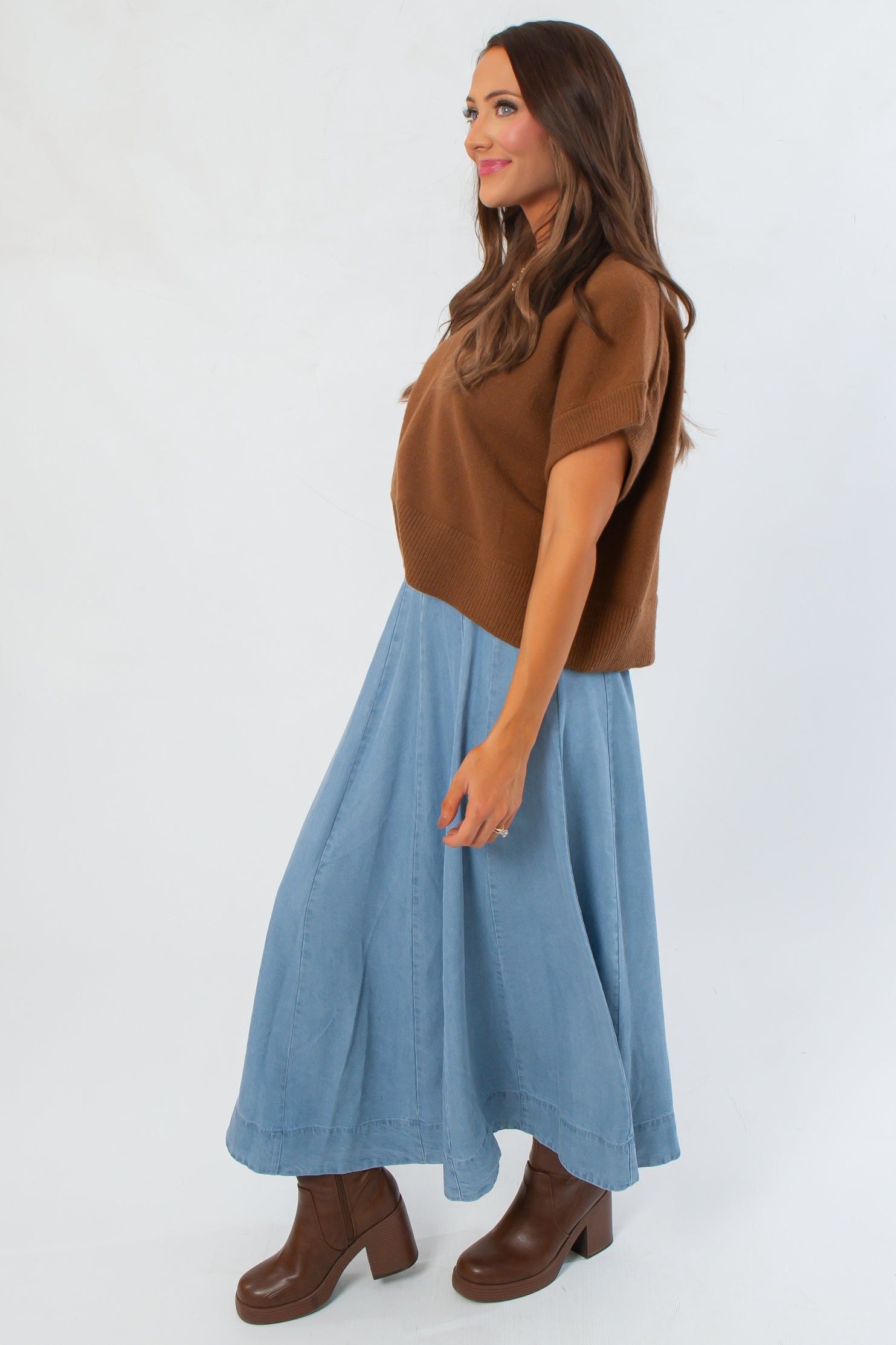 Side view of sleeveless light brown V Neck Sweater Vest, showcasing relaxed fit and cropped cut for versatile fall styling.