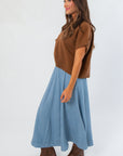Side view of sleeveless light brown V Neck Sweater Vest, showcasing relaxed fit and cropped cut for versatile fall styling.