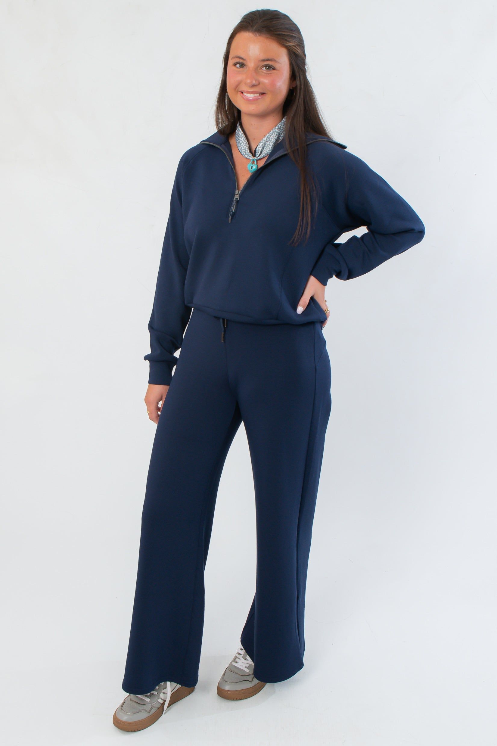 Spanx AirEssentials Half Zip in navy styled with matching pants, offering a chic and comfortable lounge set for versatile wear.