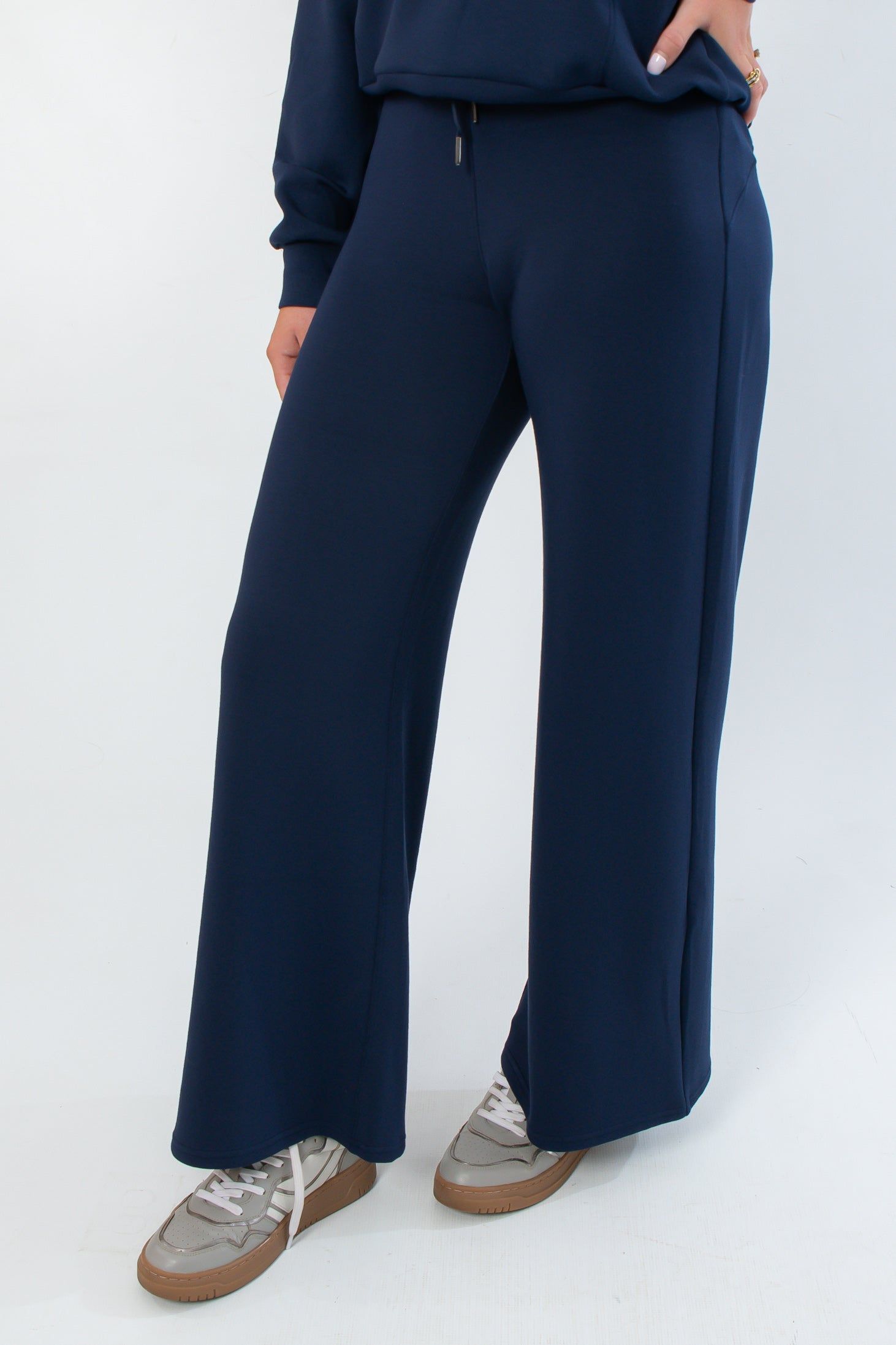 Close-up of Spanx AirEssentials Timeless Navy Wide Leg Pant highlighting soft spacer fabric and wide leg silhouette.