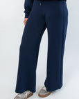 Close-up of Spanx AirEssentials Timeless Navy Wide Leg Pant highlighting soft spacer fabric and wide leg silhouette.