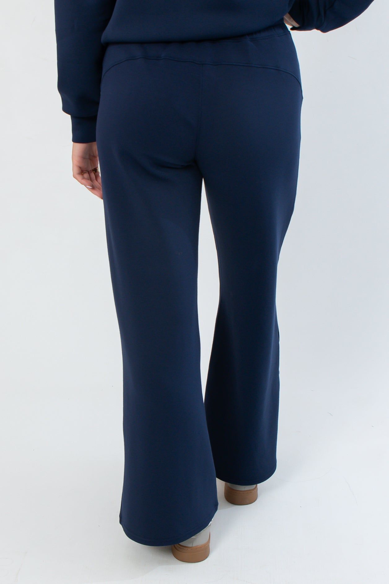 Back view of Spanx AirEssentials Timeless Navy Wide Leg Pant showing smooth fit and flowy wide leg design.