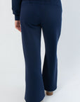 Back view of Spanx AirEssentials Timeless Navy Wide Leg Pant showing smooth fit and flowy wide leg design.