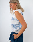 back view of woman in sleeveless knit fish sweater with blue fish pattern