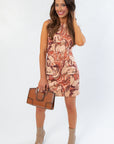 Steve Madden Sorrel Averi Dress featuring bold horse print and front pockets, paired with a brown handbag and neutral ankle boots.