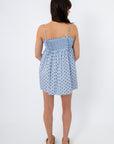 Back view of light blue polka dot smocked mini dress with adjustable straps, perfect for casual summer days