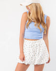 Bella Knit Bubble Hem Skirt - Blue Ditsy Floral styled with a blue ribbed tank and cap, featuring a chic-athletic silhouette and elastic waistband.