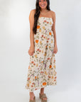 Front view of Heirloom Pumpkin Harvest Strapless Midi Dress featuring a tiered silhouette and vibrant pumpkin print for fall fashion.