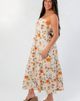 Side profile of Heirloom Pumpkin Harvest Strapless Midi Dress showing flowy fit and colorful harvest pattern, great for casual autumn wear.