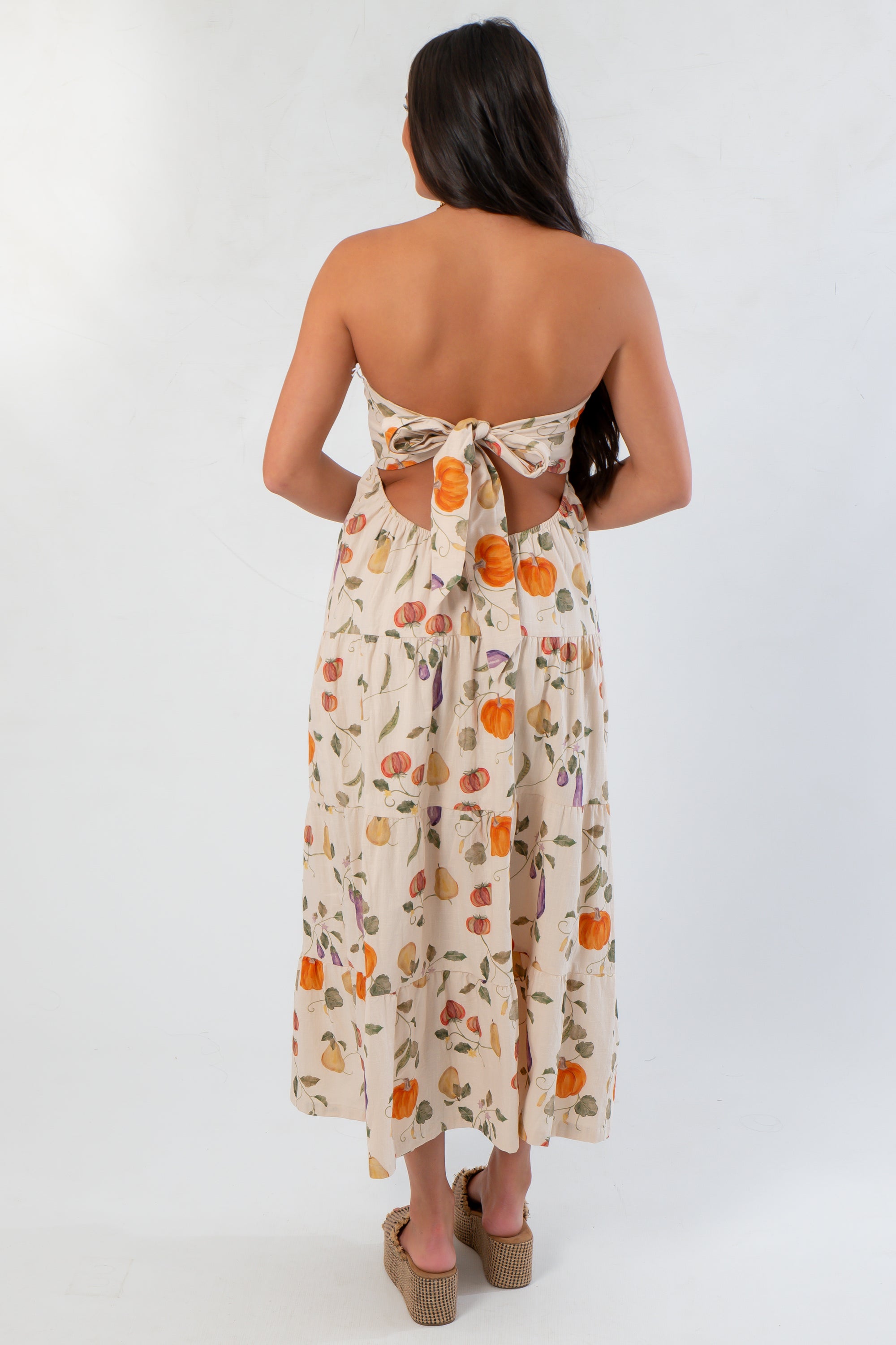 Back view of Heirloom Pumpkin Harvest Strapless Midi Dress with bow tie detail and open back, ideal for stylish fall gatherings.