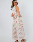 Side view of Spring Soirée White Floral Midi Dress with floral pattern and pockets