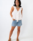 white ruffle summer top with colorful jewelry