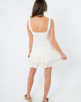 White pleated mini dress with ruffle hem for women