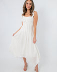 Elegant white midi dress with ruffled shoulder straps and asymmetrical hem, perfect for bridal showers