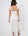White asymmetrical hem midi dress with ruffled shoulder straps, back view