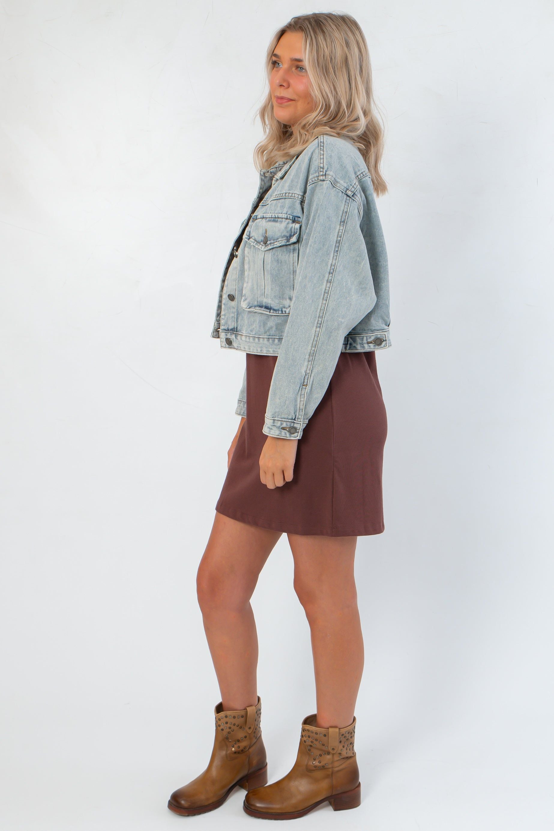 Side view of Maci Medium Wash Crop Denim Jacket – Classic & Trendy, showcasing cropped fit and relaxed silhouette in light blue denim.
