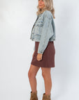 Side view of Maci Medium Wash Crop Denim Jacket – Classic & Trendy, showcasing cropped fit and relaxed silhouette in light blue denim.