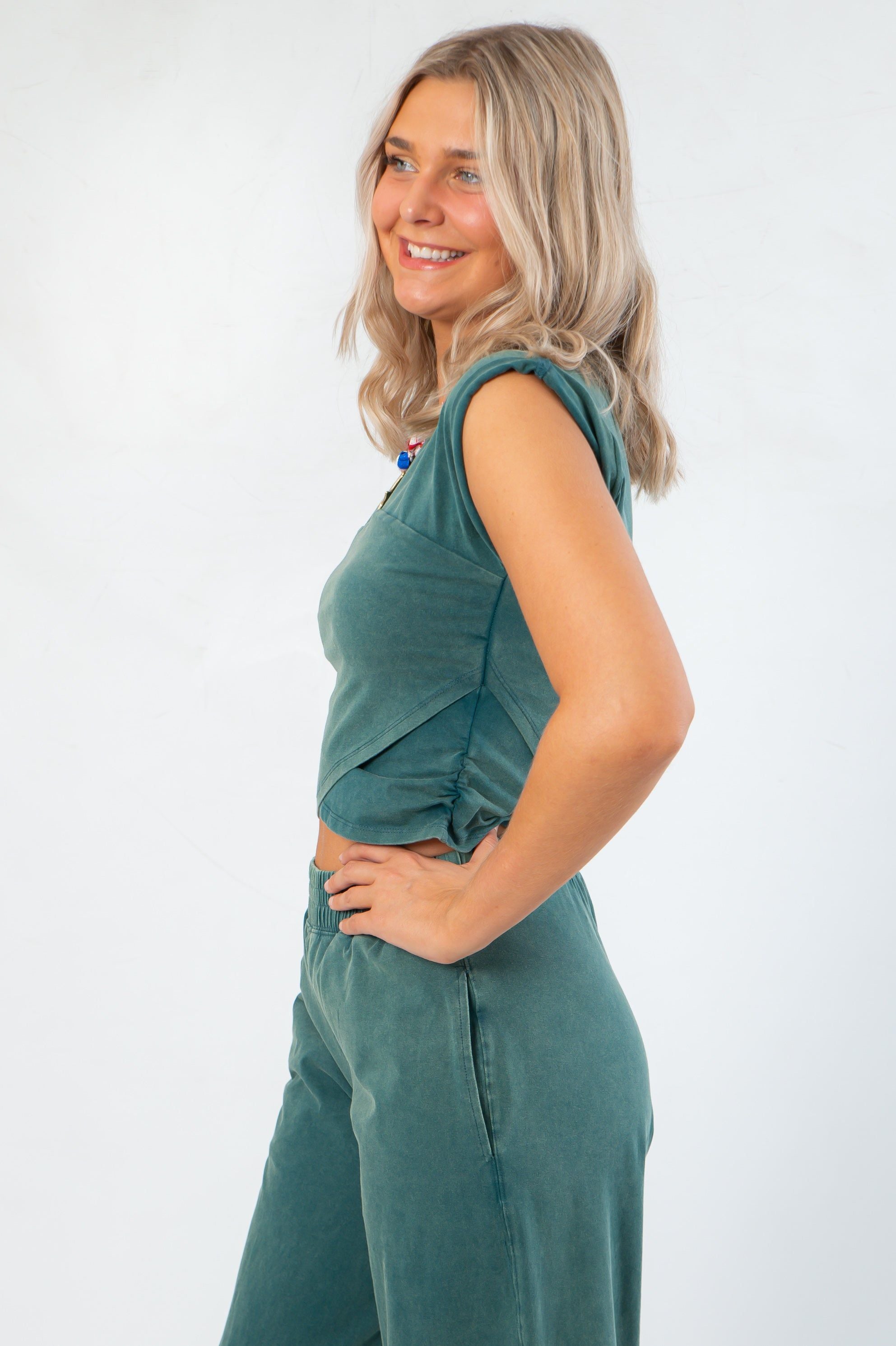 Side view of Teal Crop Top - Short Sleeve showing wrap detail and flattering fit, great for casual and fall wardrobe updates.