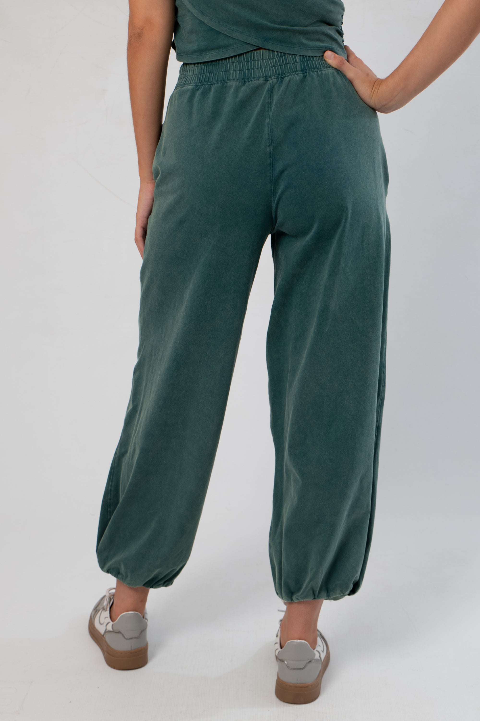 Back detail of Teal Jogger Sweatpants featuring elastic waistband and gathered ankle cuffs for a snug, stylish fit.