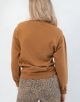 Back view of brown Grateful for Everything Graphic Star Sweatshirt showing solid color and soft knit texture, perfect for layering in fall.