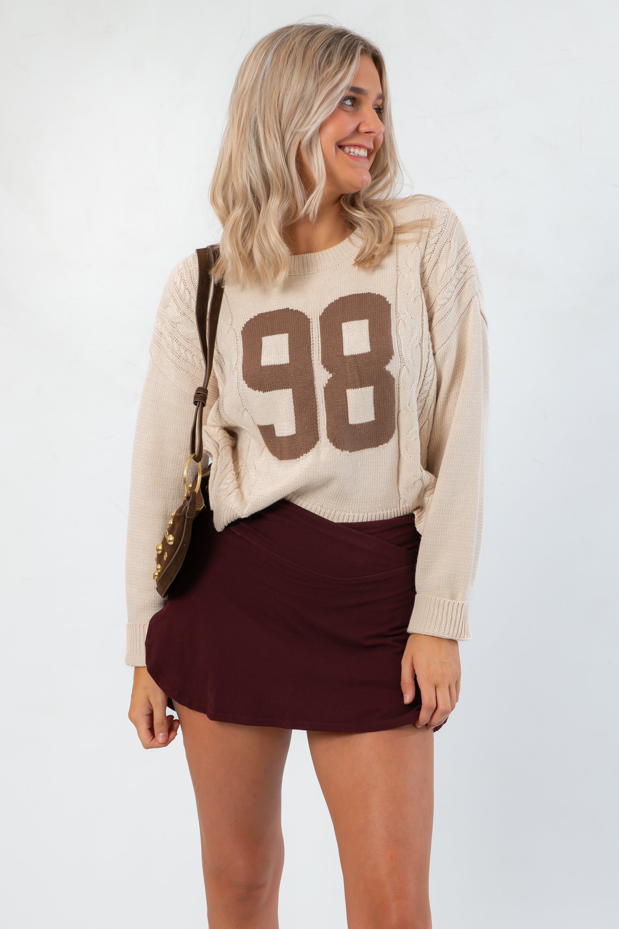 Model wearing Dark Cherry Yoga Skort with crossover detail and soft stretch fabric, styled for a cozy and sporty fall outfit.