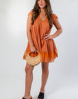 Amber Romance Lace Babydoll Dress paired with black heels and a straw handbag, perfect for fall gamedays or garden parties.