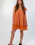 Front view of Amber Romance Lace Babydoll Dress showcasing pleated fabric, lace hem, and relaxed babydoll silhouette.