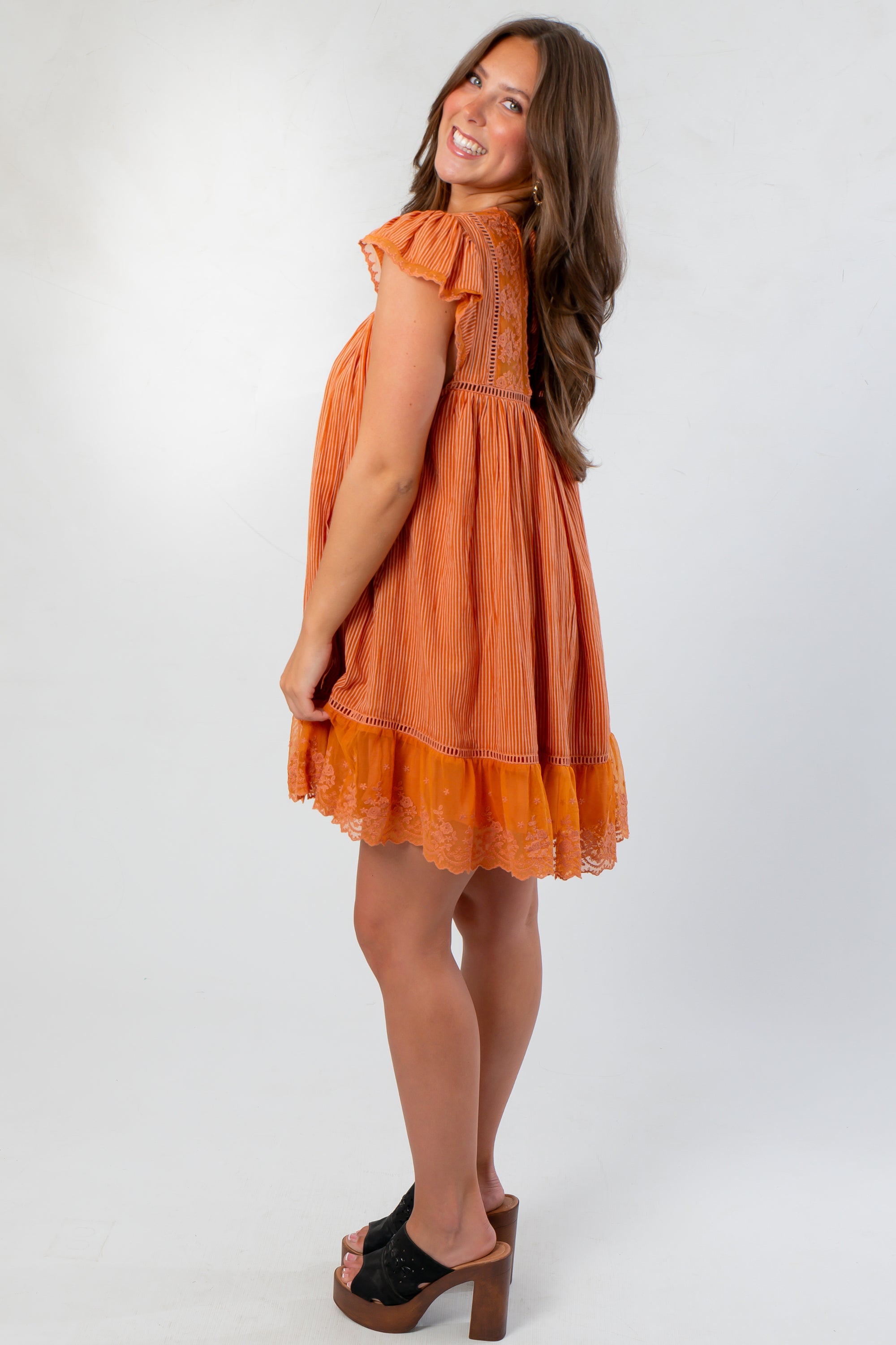 Side view of Amber Romance Lace Babydoll Dress highlighting flutter sleeves and flowy southern charm design.