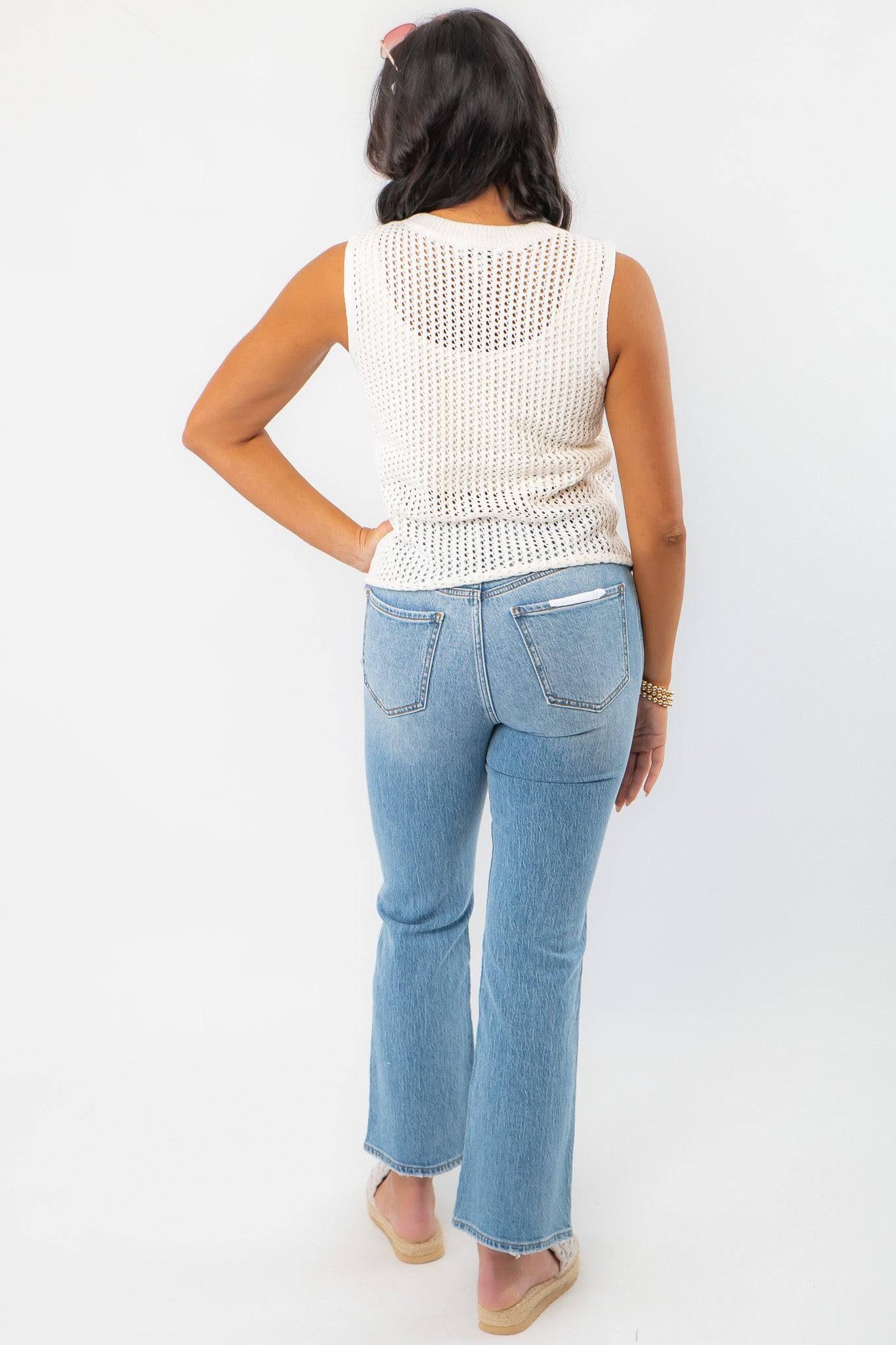 Back view of the Gia Crochet Shell Knit Tank features a sleeveless white crochet design with pastel shell patterns, perfect for effortless summer beachwear.