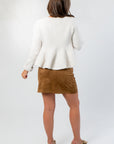 Back view of Effortless Icon Ivory Peplum Cardigan – flared hem ivory cardigan in soft knit, ideal for elegant seasonal layering.