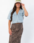 Delilah Denim Short Sleeve Woven Top styled with leopard print skirt and beige cap, perfect lightweight fall denim shirt for women.