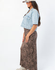 Side view of Delilah Denim Short Sleeve Woven Top showcasing cropped fit and front pockets, styled for trendy fall fashion.