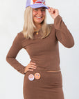 Z Supply Brown Demure Cropped Long Sleeve – Soft & Stretchy Fit, featuring fluted sleeves and a cozy cropped cut, styled with a casual cap.